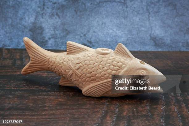 fish-shaped roman catacomb oil lamp - animal sculpture stock pictures, royalty-free photos & images