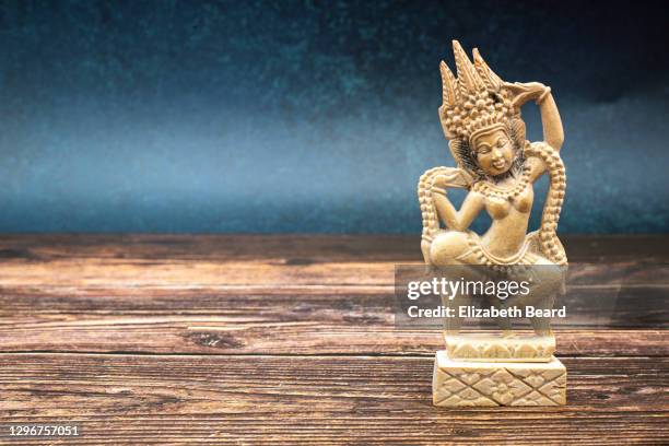 stone apsara hindu figurine from bali - balinese headdress stock pictures, royalty-free photos & images