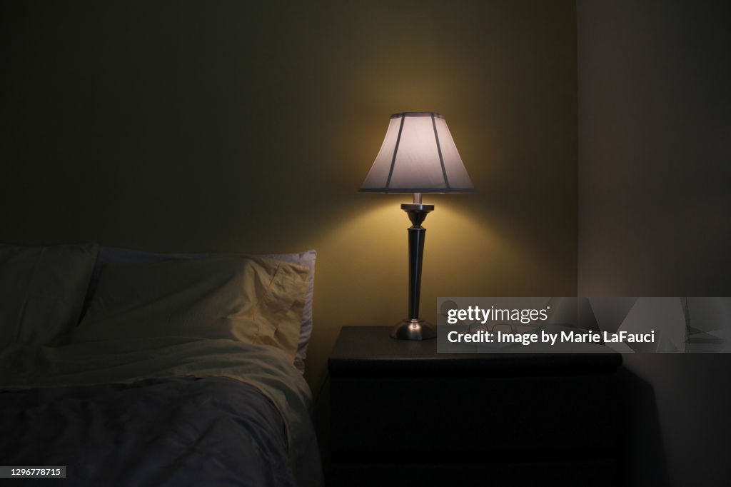 Dark bedroom with illuminated light