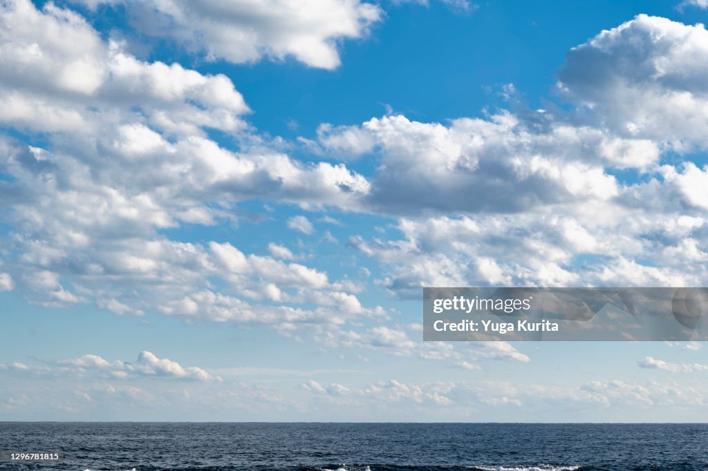 White Clouds in a Blue Sky over a Sea