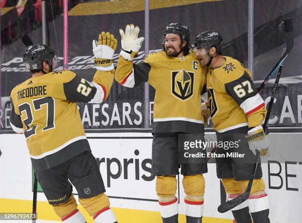 Shea Theodore, Mark Stone and Max Pacioretty of the Vegas Golden Knights celebrate after Stone assisted Pacioretty on an overtime goal against the...