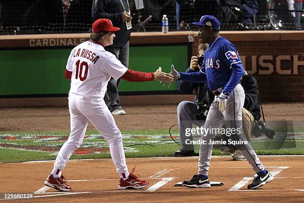 Managers Tony La Russa of the St. Louis Cardinals and Ron Washington of the Texas Rangers shake hands prior to the start of Game One of the MLB World...