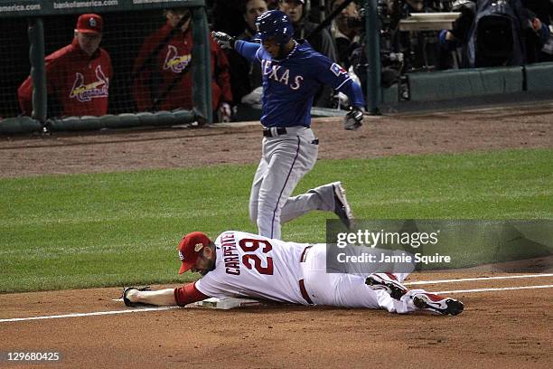 Chris Carpenter of the St. Louis Cardinals tags first base for an out to beat Elvis Andrus of the Texas Rangers during Game One of the MLB World...