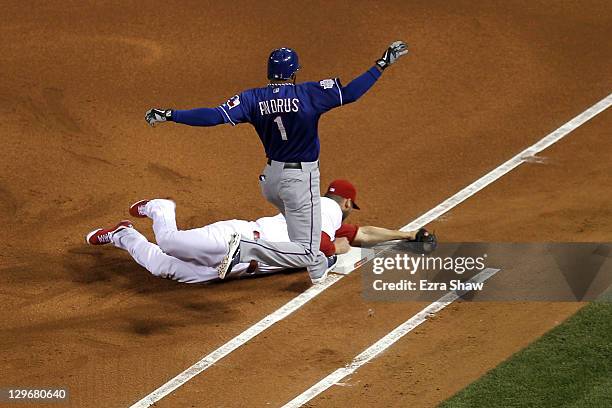 Chris Carpenter of the St. Louis Cardinals tags first base for an out to beat Elvis Andrus of the Texas Rangers during Game One of the MLB World...