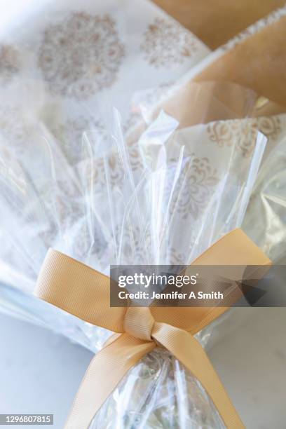 ribbon tied in a bow - cellophane stock pictures, royalty-free photos & images