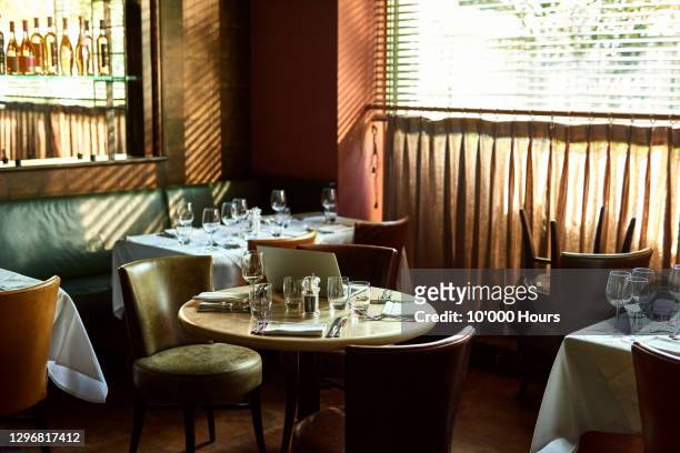 restaurant interior with laptop on table - tisch besteck leer stock-fotos und bilder