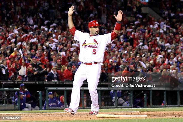Albert Pujols of the St. Louis Cardinals reacts after scoring a run in the bottom of the fourth inning against the Texas Rangers during Game One of...
