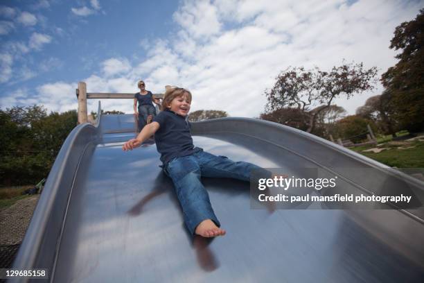 smiling boy on slide - toboggan photos et images de collection
