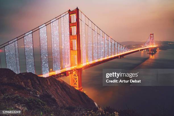 the golden gate bridge at night shining with glitter effect at night. - golden gate bridge night 個照片及圖片檔