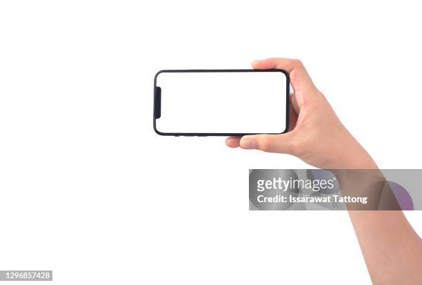 smartphone in female hands taking photo isolated on white blackground - hand mobile stock-fotos und bilder