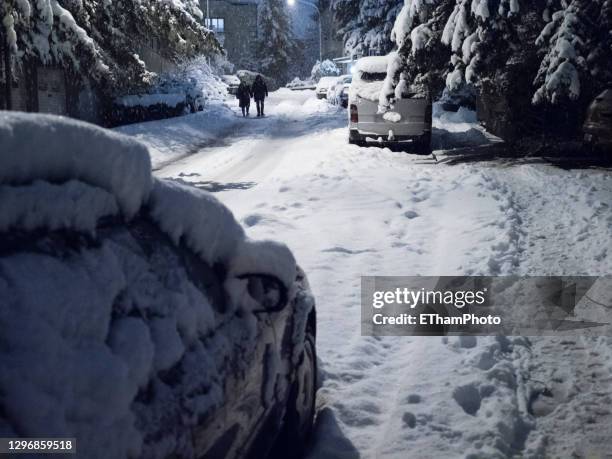 parked cars in the morning twilight on the streetside after heavy snowfall - zurich winter stock pictures, royalty-free photos & images