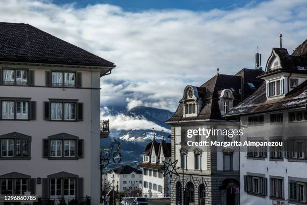 view through the buildings in schwyz town in switzerland - schwyz stock pictures, royalty-free photos & images