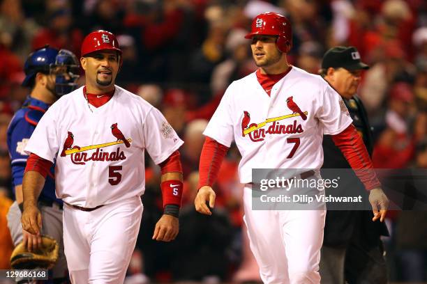 Albert Pujols and Matt Holliday of the St. Louis Cardinals celebrate after scoring on a two-RBI single in the bottom of the fourth inning by Lance...