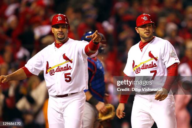 Albert Pujols and Matt Holliday of the St. Louis Cardinals celebrate after scoring on a two-RBI single in the bottom of the fourth inning by Lance...