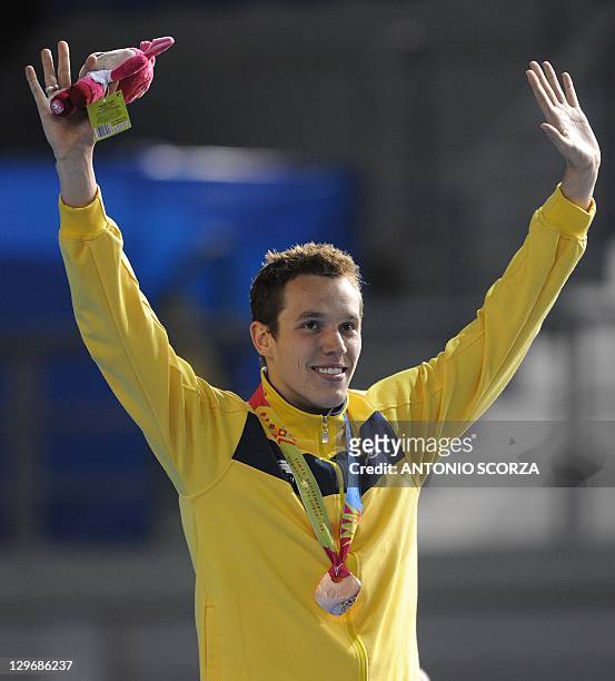 Brazil's Henrique Rodrigues, bronze medalist, celebrates on the podium of the men's 200-metre individual medley swimming event during the 2011 Pan...