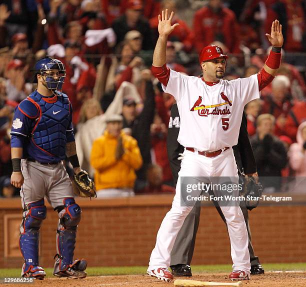 St. Louis Cardinals' Albert Pujols scores in front of Texas Rangers catcher Mike Napoli in the fourth inning in Game 1 of the World Series at Busch...