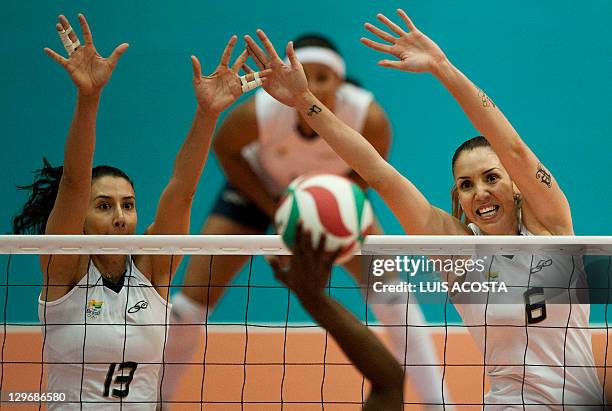 Brazil's Sheila Castro and Thaisa Menezes block the ball against the Domican Republic during their semifinal volleyball match at the Pan American...