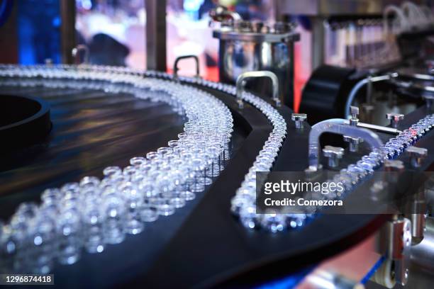transparent glass bottles at production line - pharmafabrik stock-fotos und bilder
