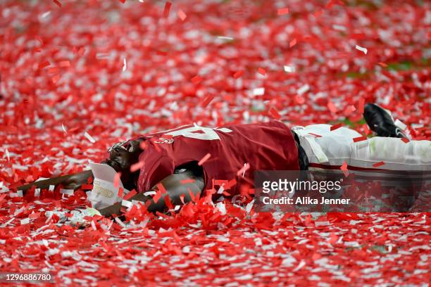 Joshua McMillon of the Alabama Crimson Tide makes confetti angels after the College Football Playoff National Championship football game against the...