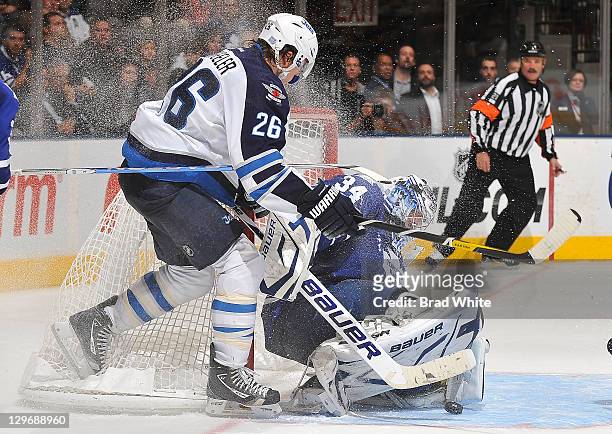 James Reimer of the Toronto Maple Leafs makes a pad save on Blake Wheeler of the Winnipeg Jets during NHL game action October 19, 2011 at Air Canada...