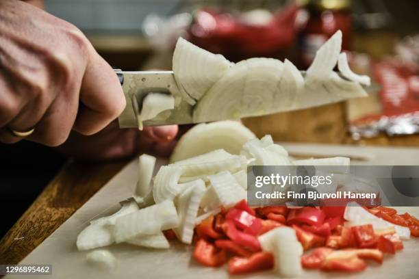 hand cutting onions and red peppar with a knife - chopped stock pictures, royalty-free photos & images