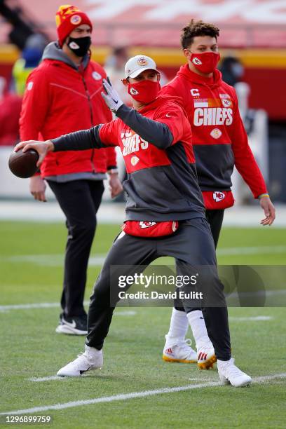 Quarterback Chad Henne of the Kansas City Chiefs warms up as quarterback Patrick Mahomes and Kansas City Chiefs quarterback coach Mike Kafka look on...