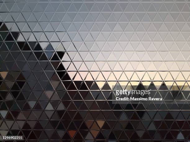 metallic surface reflecting sunset. - wall building feature stock pictures, royalty-free photos & images