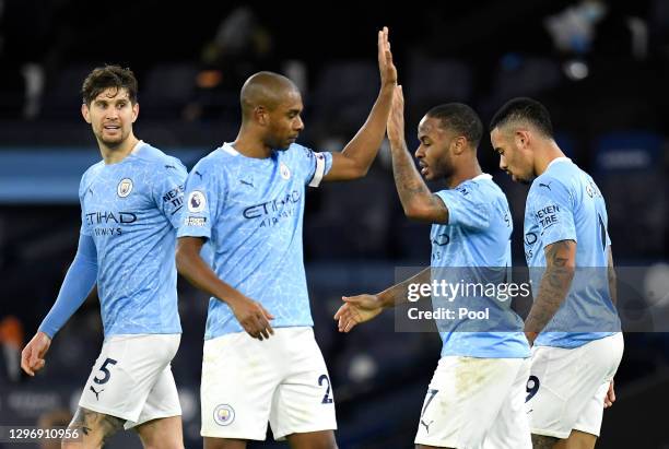 Raheem Sterling of Manchester City celebrates with team mates John Stones, Fernandinho and Gabriel Jesus after scoring their side's fourth goal...