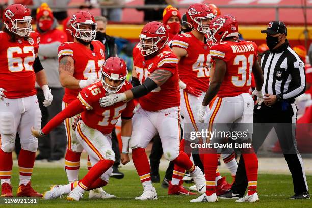 Quarterback Patrick Mahomes of the Kansas City Chiefs is assisted by offensive tackle Mike Remmers after an injury from a sack that would remove...