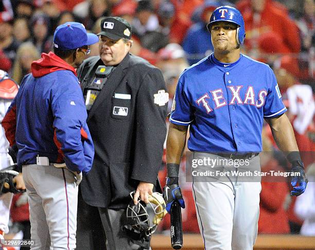 Texas Rangers manager Ron Washington, left, argues with umpire Jerry Layne as Adrian Beltre claims to foul the ball off of his foot, but the umpire...