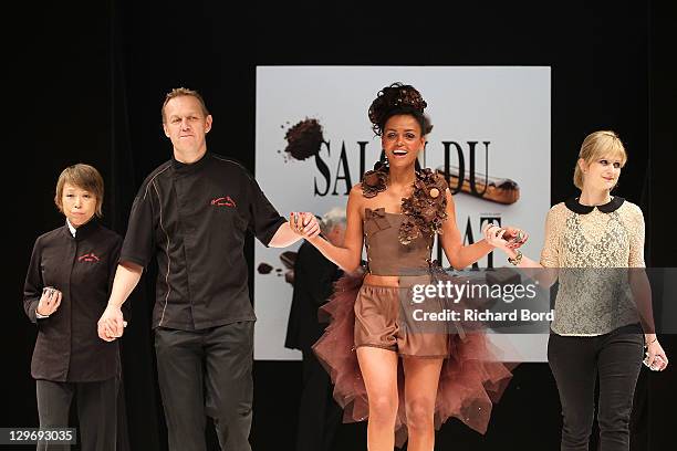 Laurence Roustandjee walks the runway with Manon Bresson and Jean-Marc Rue, during the chocolate dress fashion show celebrating 'Salon du Chocolat...