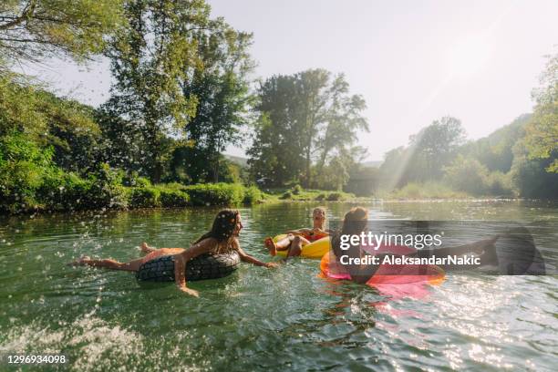 best friends and summertime - river inner tube stock pictures, royalty-free photos & images