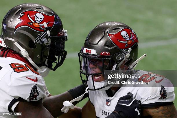 Sean Murphy-Bunting of the Tampa Bay Buccaneers celebrates with Jason Pierre-Paul after intercepting a pass thrown by Drew Brees of the New Orleans...