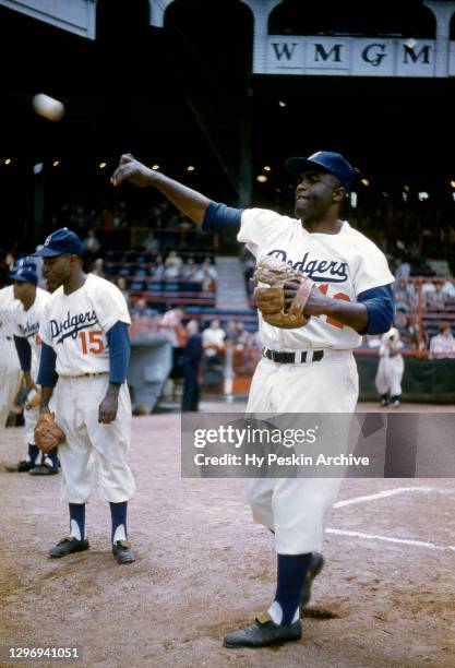 Jackie Robinson and Sandy Amoros of the Brooklyn Dodgers warm-up prior to an MLB game against the Philadelphia Phillies on May 22, 1955 at Ebbets...