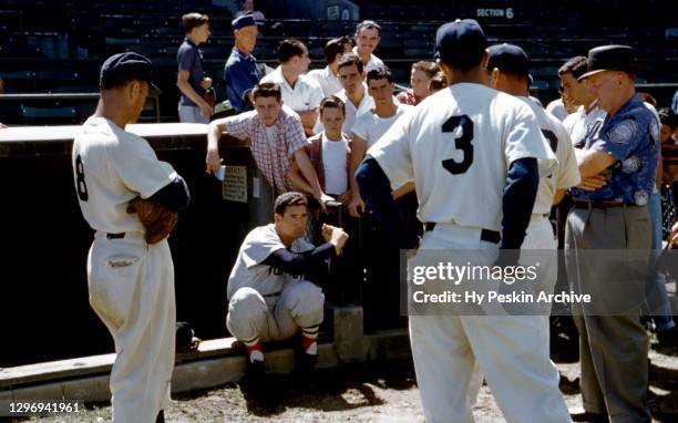 Ted Williams of the Boston Red Sox shows his swing to fans and players of the Brooklyn Dodgers during Spring Training on March 18, 1956 in Vero...