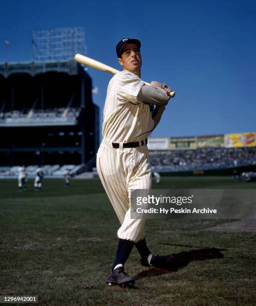 Joe DiMaggio of the New York Yankees poses for an action portrait circa 1950 at Yankee Stadium in the Bronx, New York.