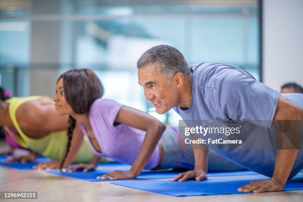 multi ethnic group yoga fitness class - cores stock pictures, royalty-free photos & images