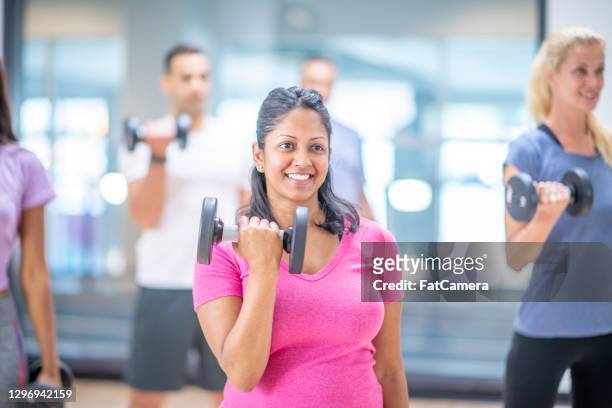 pregnant woman at group fitness class - cores stock pictures, royalty-free photos & images
