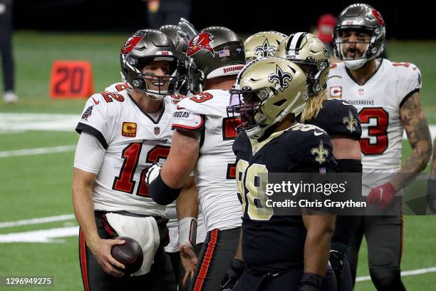 Tom Brady of the Tampa Bay Buccaneers celebrates with his teammates after scoring a touchdown against the New Orleans Saints during the fourth...