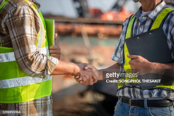 shipyard engineers and technicians who are discussing work on site - construction crane asia stock pictures, royalty-free photos & images
