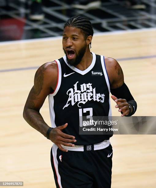 Paul George of the LA Clippers reacts after his dunk over Justin Holiday of the Indiana Pacers during the first half at Staples Center on January 17,...