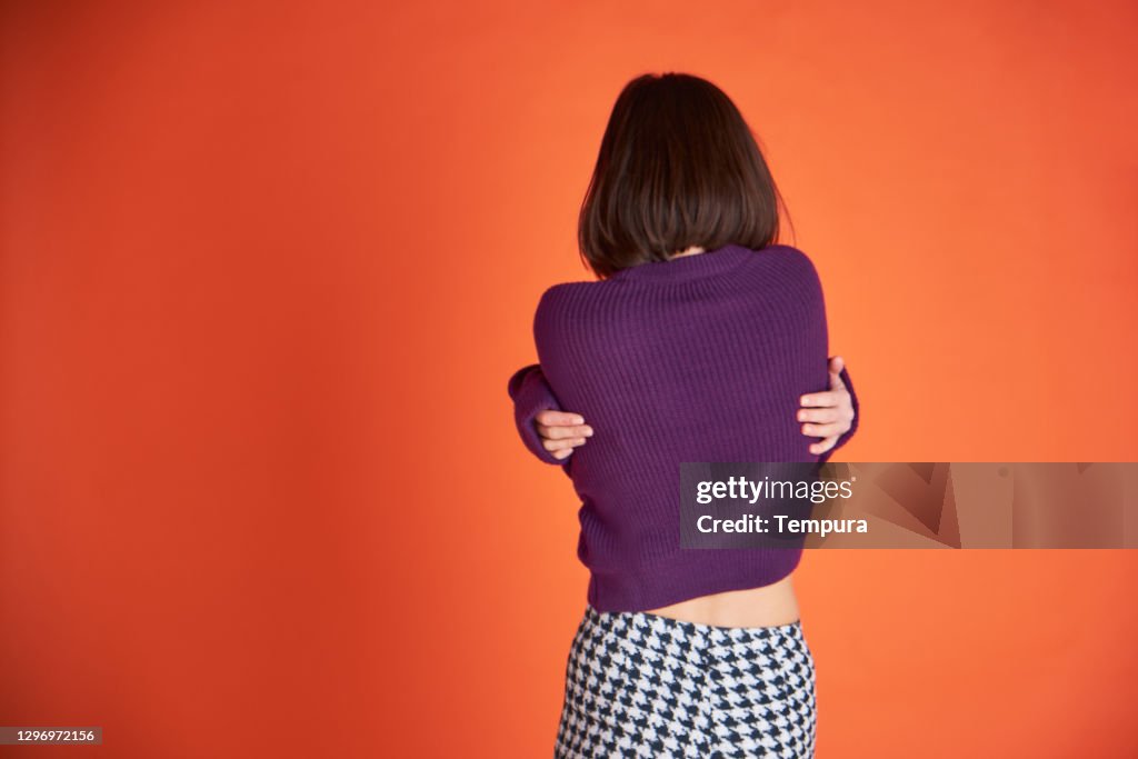 One Young woman wearing a purple sweater