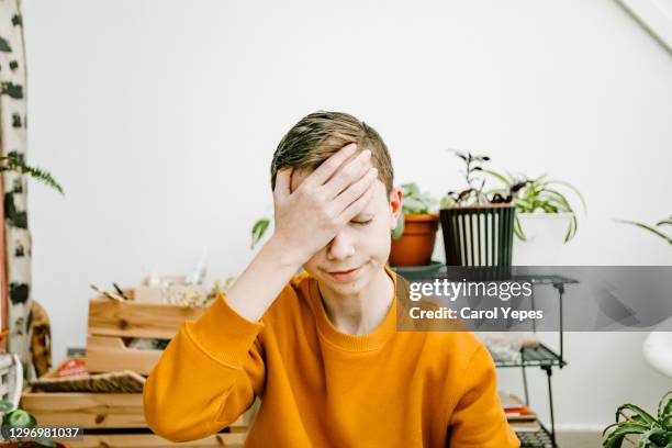 depressed teenager male. - headache child fotografías e imágenes de stock