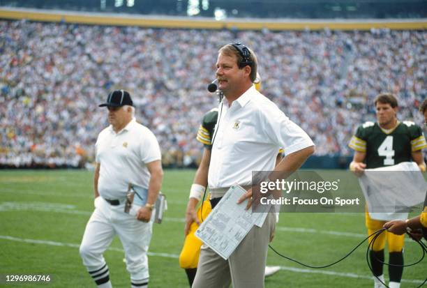 Head coach Mike Holmgren of the Green Bay Packers looks on from the sidelines during an NFL football game circa 1992 at Lambeau Field in Green Bay,...