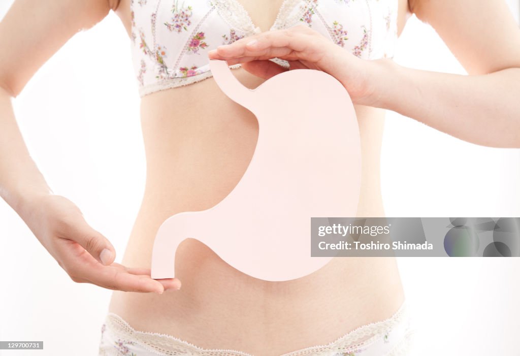 Human hand holding stomach shape