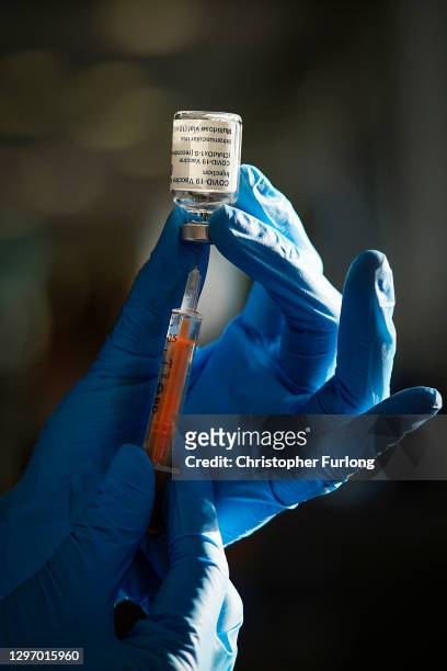 Nurse draws the Oxford-AstraZeneca Covid-19 coronavirus vaccine into a hypodermic needle at Totally Wicked Stadium home of St Helen's rugby club, one...
