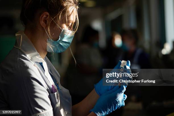 Nurse draws the Oxford-AstraZeneca Covid-19 coronavirus vaccine into a hypodermic needle at Totally Wicked Stadium home of St Helen's rugby club, one...