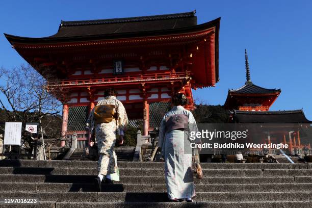 Women dressed in kimonos walk through a deserted Kiyomizu Temple normally crowded with tourists on January 18, 2021 in Kyoto, Japan. Kyoto, along...