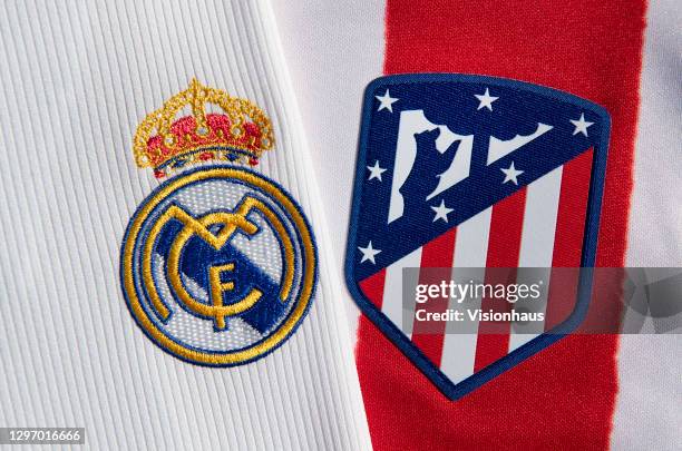 The Real Madrid and Atlético Madrid club crests on the first team home shirts on January 12, 2021 in Manchester, United Kingdom.