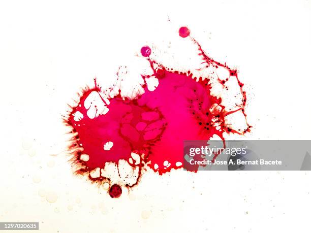 full frame of abstract shapes and textures formed by colored liquids on a white background. - bespatterd stockfoto's en -beelden